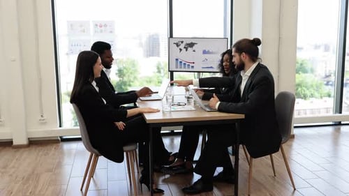 Business People Holding Hands Together in Meeting Room