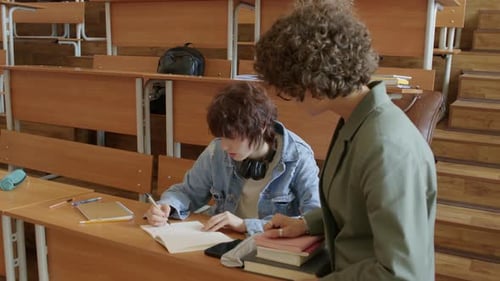 Students Collaborating on Writing Task in Lecture Hall