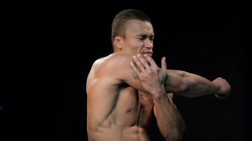 Muscular Man Rubbing Shoulder With Visible Pain