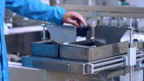 Pharmaceutical Manufacturing Process. Close Up of Worker Hands Working with Pharmaceutical Packaging
