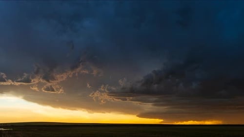 Dramatic Storm Clouds at Golden Hour Over Prairie