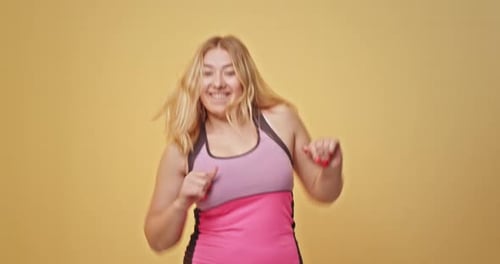 Happy Overweight Female Dancing Energetically