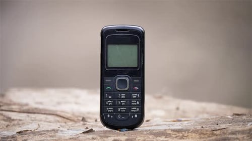 Furious Businessman Smashes Old Styles Button Mobile Phone with Sledgehammer
