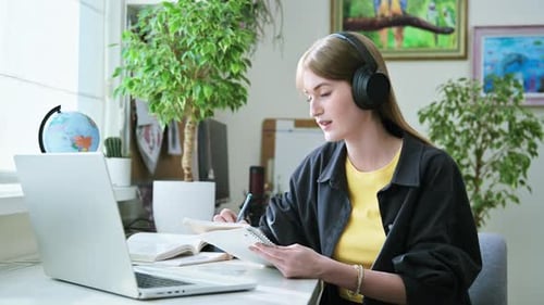 Woman Studying at Home with Laptop and Headphones