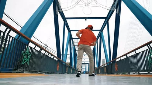 Skilled hipster perform footstep at bridge with low angle camera. Sprightly.