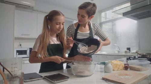 Woman and Child Baking Together in Kitchen