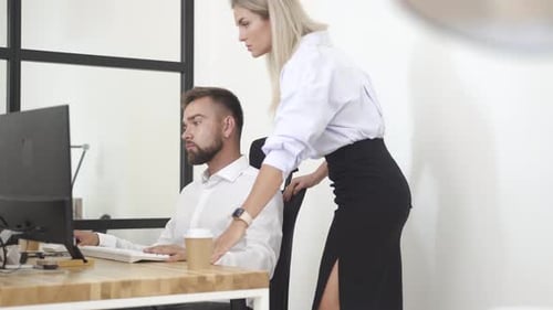 Female Manager Helping Employee During Working Day in the Office