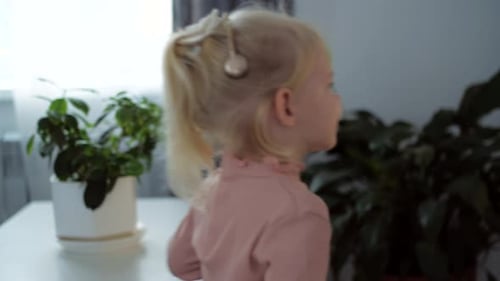 A Girl with a Cochlear Implant Watches TV and Hears Sounds