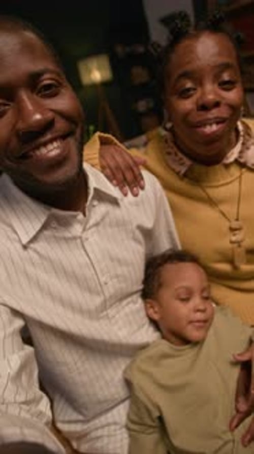 Happy Family Smiling at the Camera Indoors