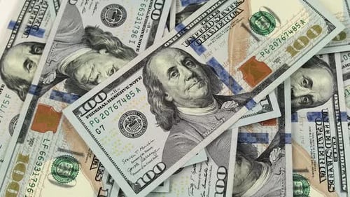 One hundred dollar banknotes rotate. 100 dollar bills close up in camera motion.