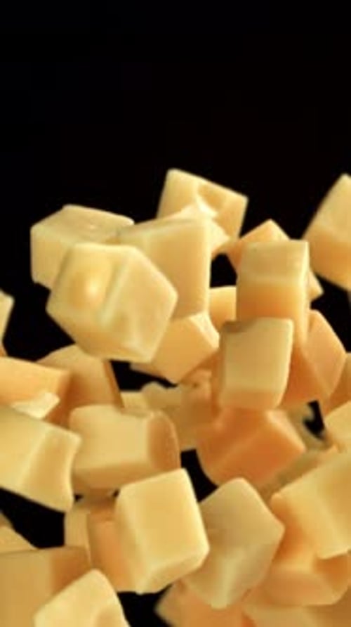 Maasdam Cheese Flies Up and Falls Down on a Black Background Filmed on a Highspeed Camera at 1000