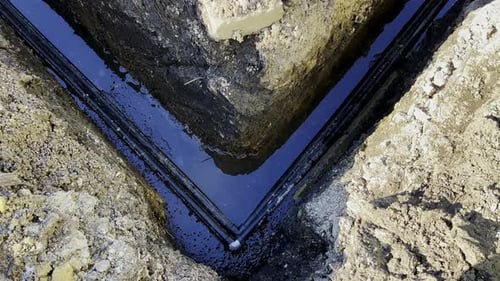 Aerial Close Up of Ground Trench with Pipes