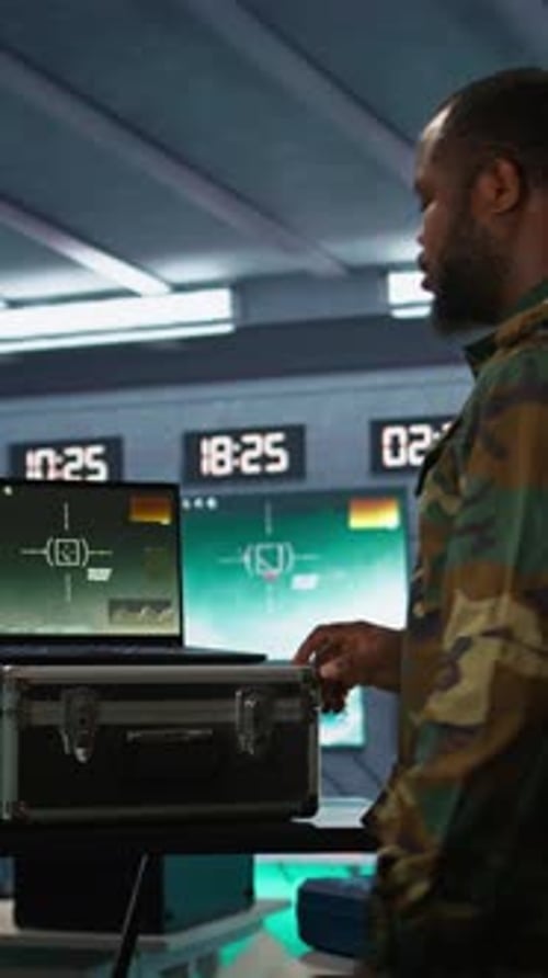 Men in Camouflage Analyzing Data in Command Center