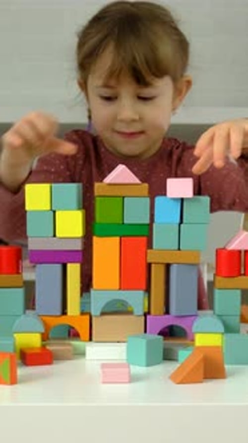 A Child Plays with Wooden Blocks Selective Focus
