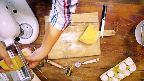 Preparing Homemade Pasta Dough with Machine on Table
