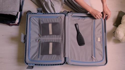 Female Tourist is Packing Luggage for Vacation