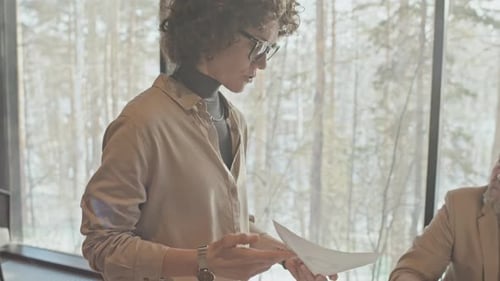 Business Professionals Discussing Documents in Modern Office