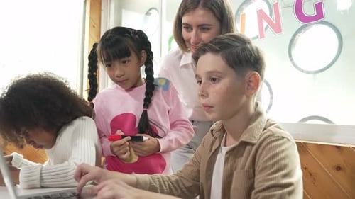 Children Learning Code with Teacher in Classroom