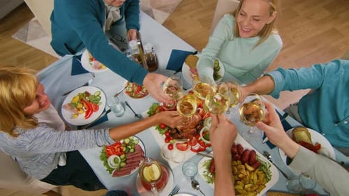 Family Gathering Around a Dinner Table, Clinking Glasses
