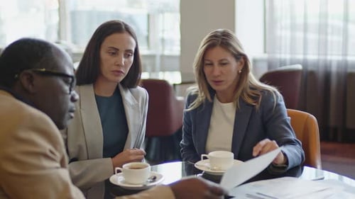 Business Team Working with Documents on Meeting in Hotel Restaurant