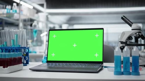 Green Screen Laptop and Scientific Gear in Research Facility