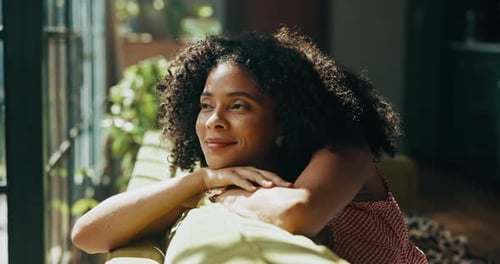 Happy, thinking and woman by window with ideas, inspiration and daydreaming on sofa