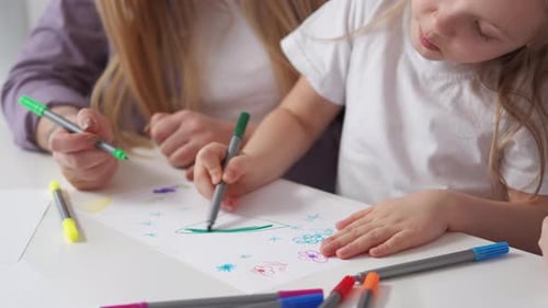 Mother and Daughter Drawing Together at Home