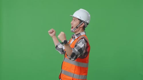 Side View Of Asian Male Engineer Celebrating Working In The Green Screen Background
