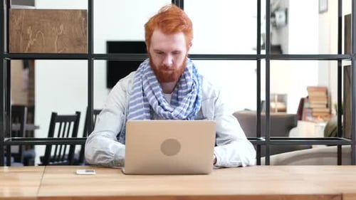 Thumbs Up By Man Working on Laptop