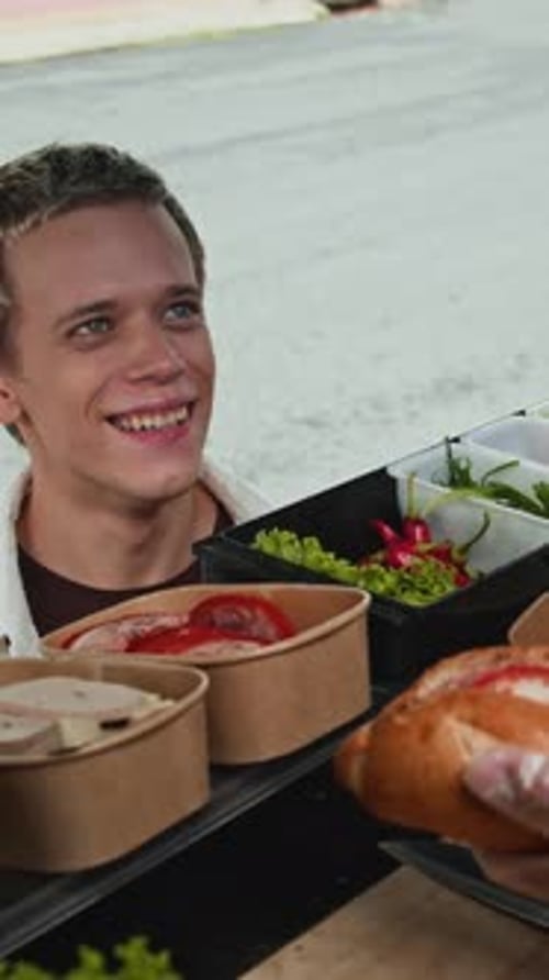 Young Man Orders Sandwich at Urban Eatery