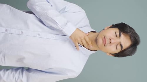 Young Man Experiencing Sore Throat and Discomfort