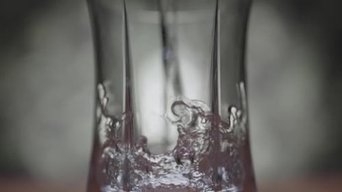Water Pouring into a Glass Container