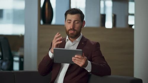 Serious Entrepreneur Videocalling Pad at Big Hall Closeup Business Man Talking