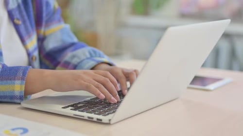 Close Up of Young African Woman Typing on Laptop