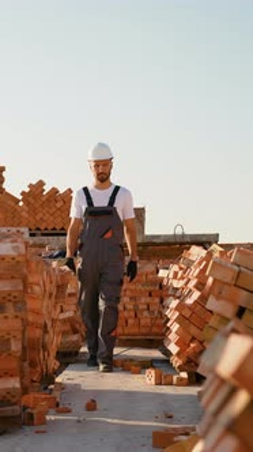 Construction Worker Walking on a Building Site