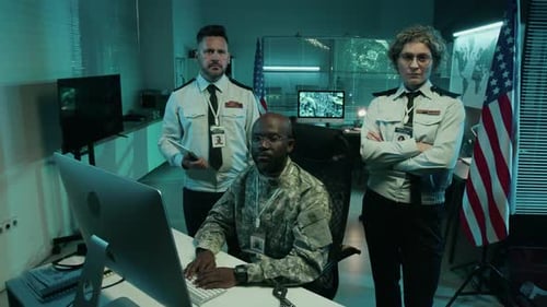 Portrait of Diverse USA Army Headquarters Staff by Computer in Command Center