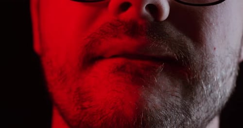 Close-Up of Man’s Lips Under Red Light – Tension and Emotion