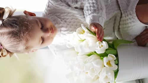 Child with White Tulips in Home Setting