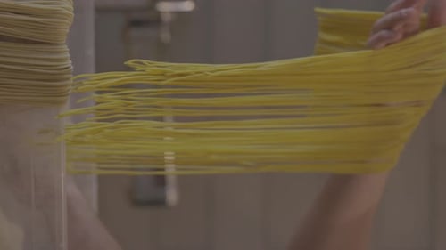 Italian Pasta Being Made on the Machine for Cutting Dough Fresh Handmade Pasta Machine Rolling Dough