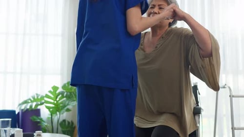 Caregiver Assisting Senior Woman with Arm Exercises