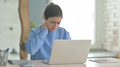 Young Woman Experiencing Neck Pain While Using Laptop