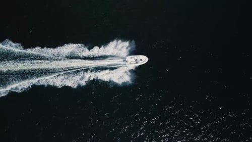 Top View of a Motorboat Cruising at High Speed in the Deep Blue Ocean