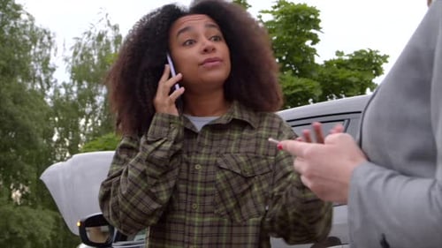 Portrait of Black Female Driver of Smashed Car Calling for Roadside Assistance