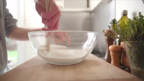 Person taking away his vintage cooking scale to mix the ingredients in the bowl. The ingredients are