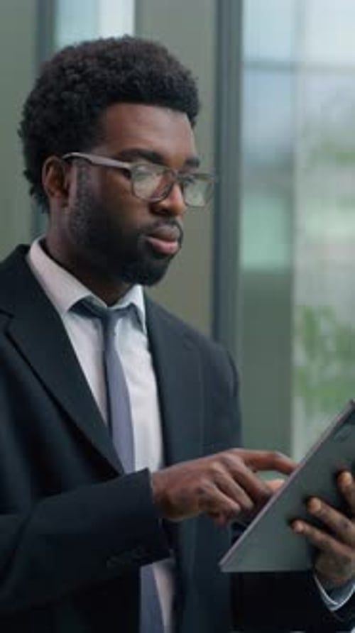 Thoughtful African American Businessman in Office Concentrate Using Digital Tablet Looking Out