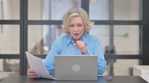 Senior Woman Working in Office Gives Thumbs Down