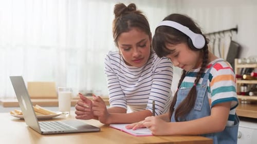 Girl Studies with Mother at Kitchen Table