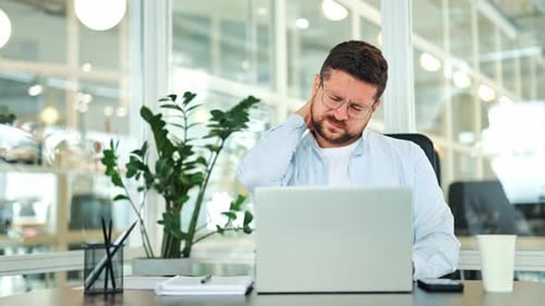 Overworked Man Experiencing Neck Ache at Office Desk