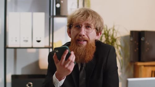 Young Business Man Working Having Mobile Phone Talk at Office Workplace Using Messenger Chat Apps