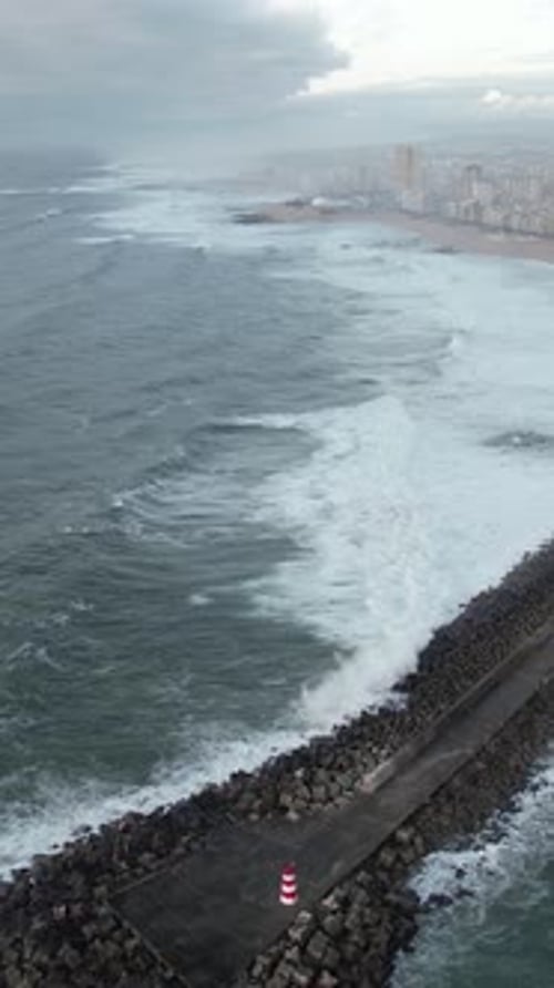 Vertical Video of Big Waves Crashing on the Pier on Storm Day